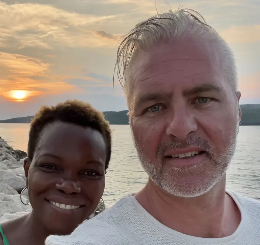 Kevin-Joel and Natasha Coupland selfie in front of a sunset