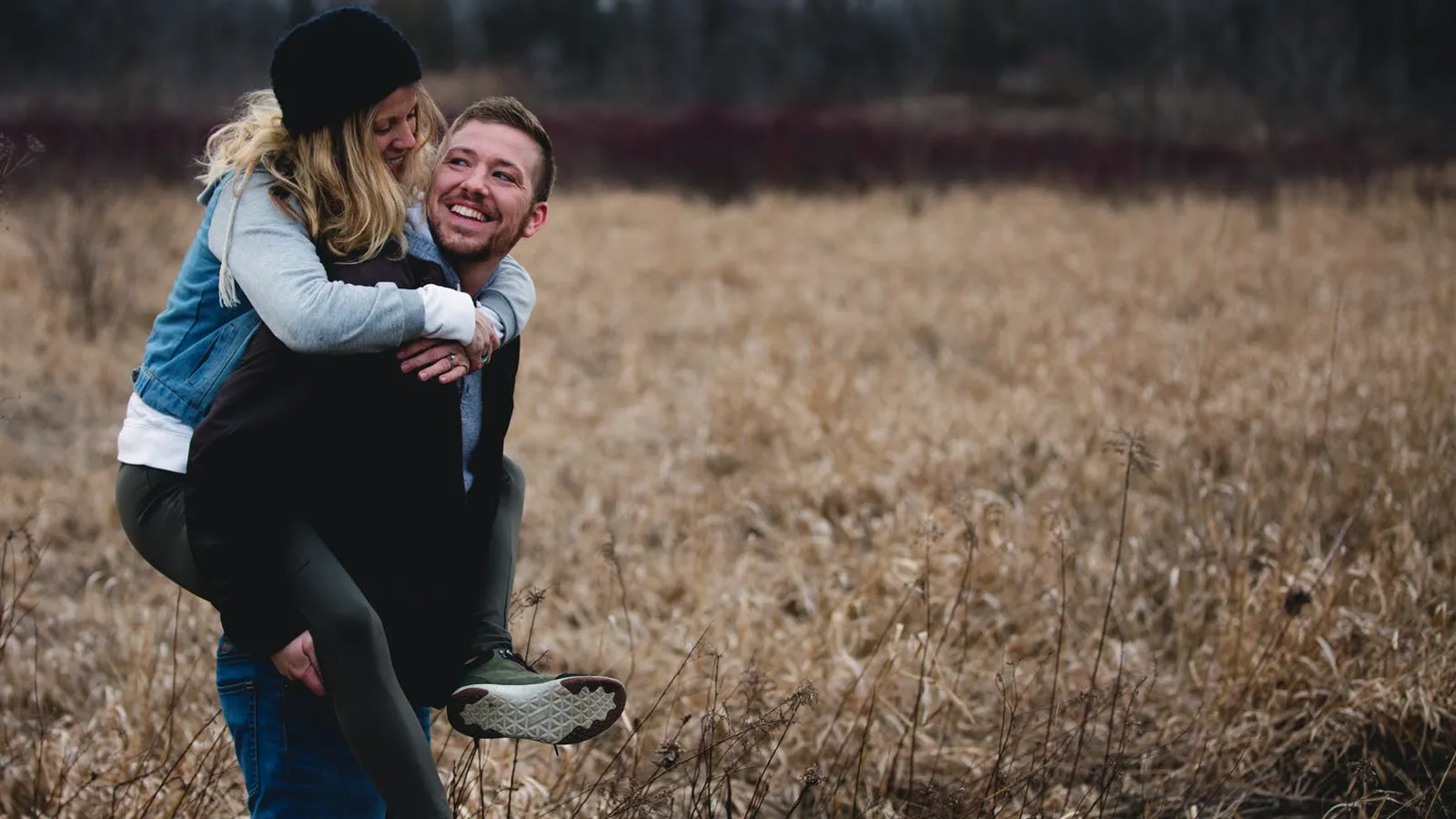Couple sharing a playful piggyback ride outdoors